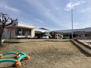 笛吹市御坂町内の保育園で砂入れボランティアを行っている様子。